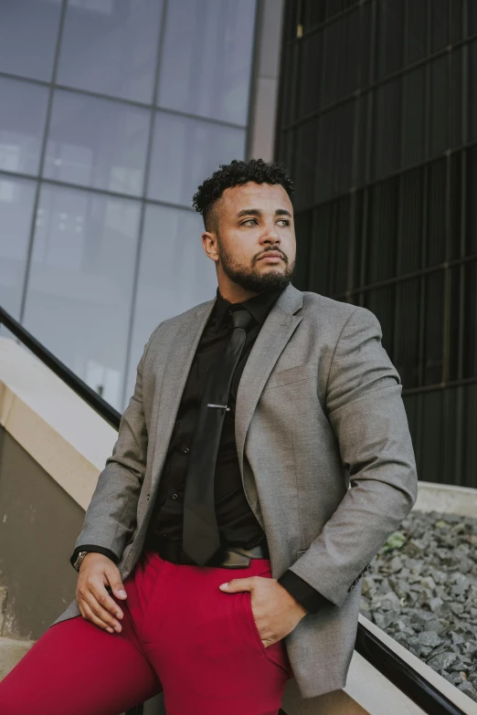 a man in a jacket and tie posing for a po