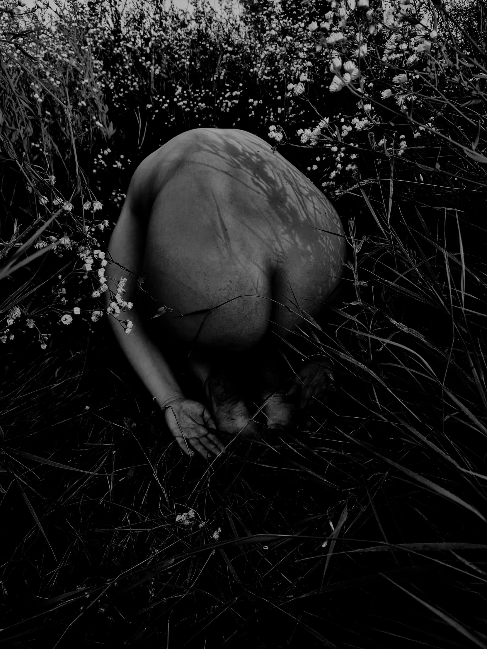 a man who is laying down in the grass