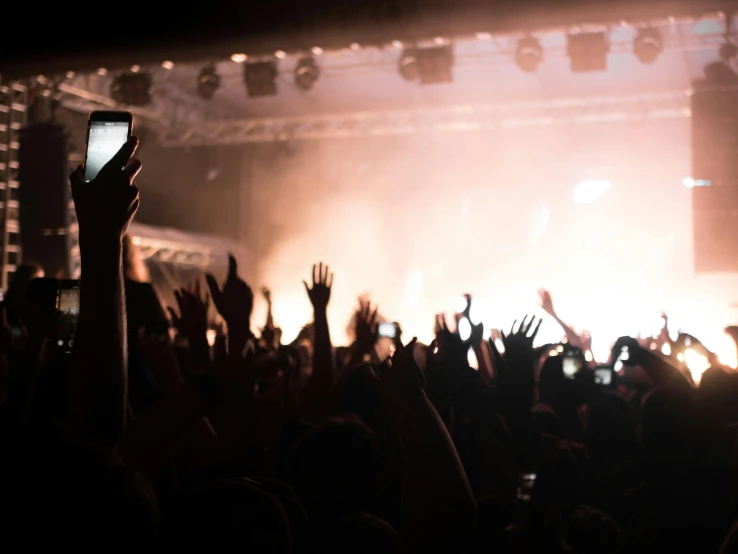 the crowd is watching an electronic device on display