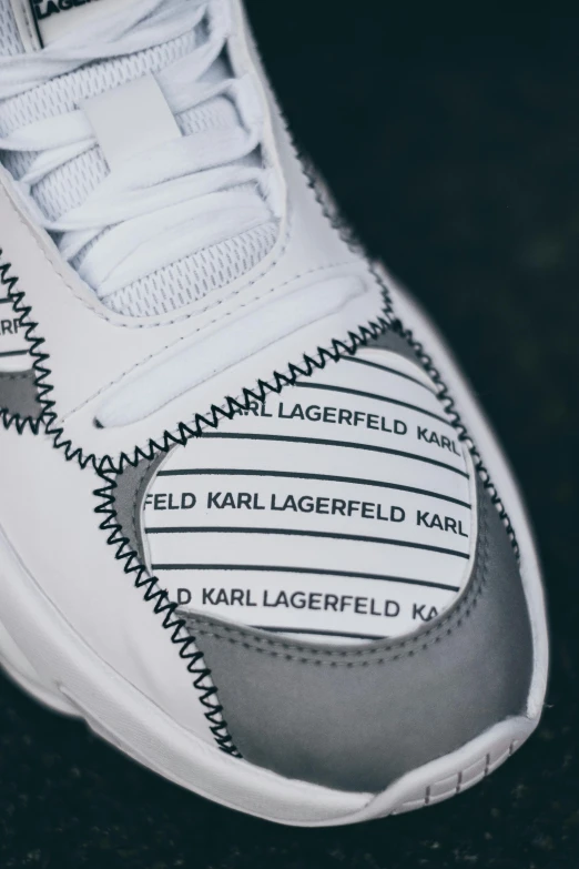 an image of a white and grey sneakers on the floor