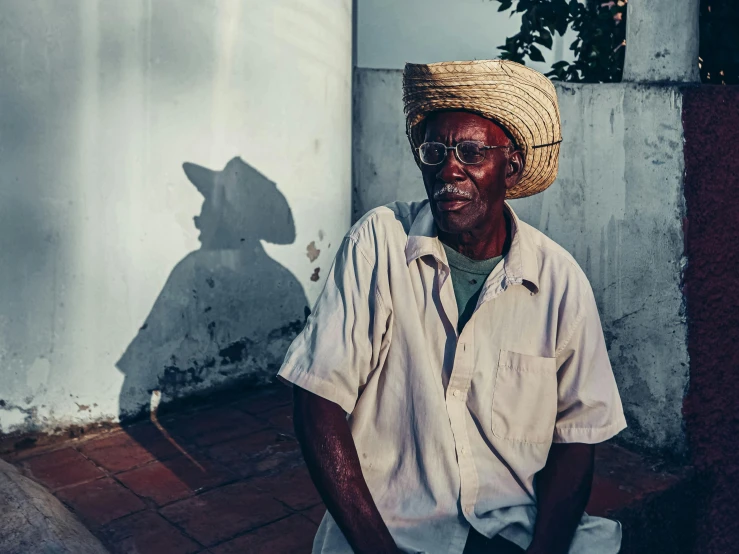 a man wearing a hat in front of a building