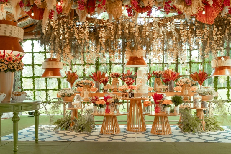 an elegant table set with flowers and orange lamps