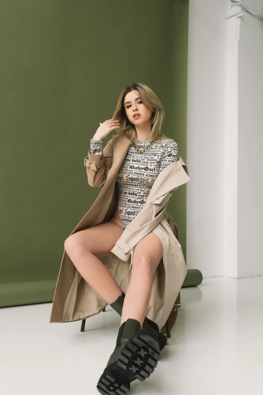 a young woman is sitting down and wearing boots