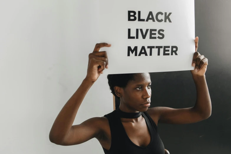 a woman holding a black lives matter sign