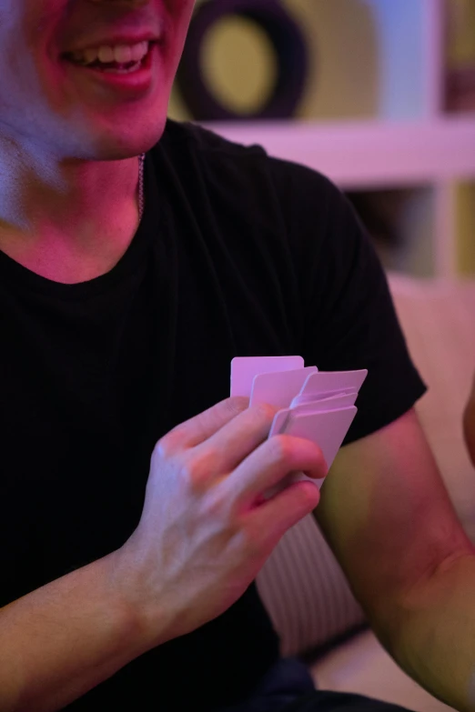 a close up of a person playing cards with a blurry background