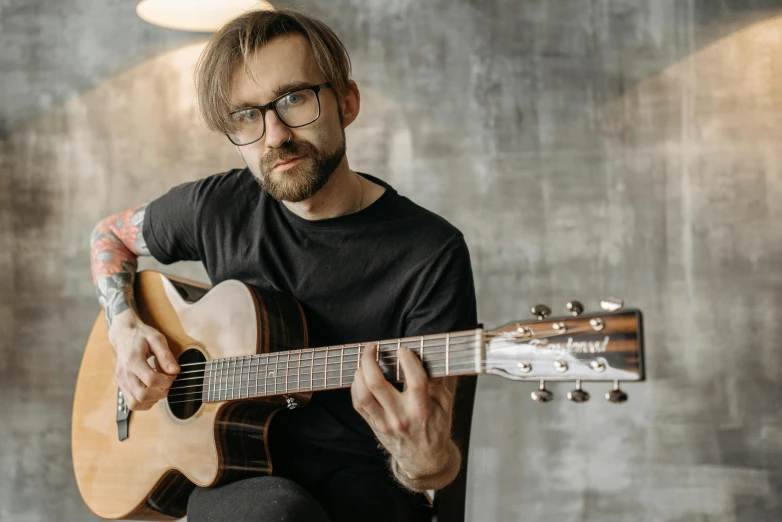 a man with a beard playing an ukelera