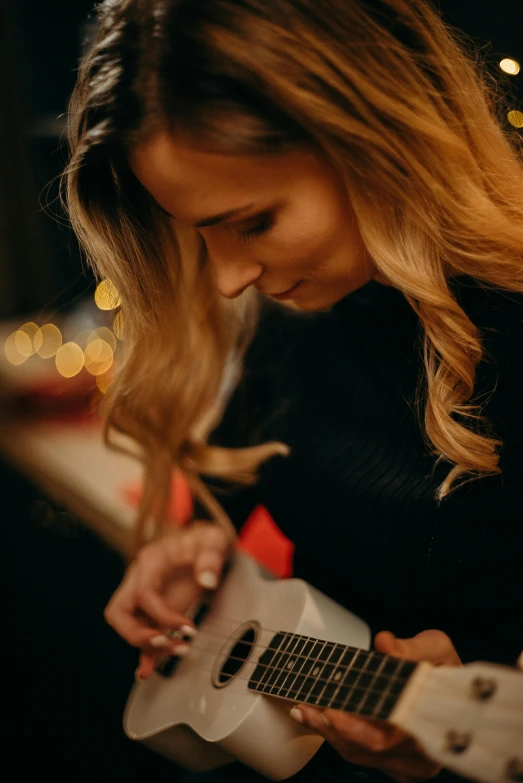 a  playing on her guitar