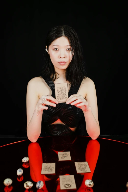 a woman sits cross legged on her legs near a display of bottle caps