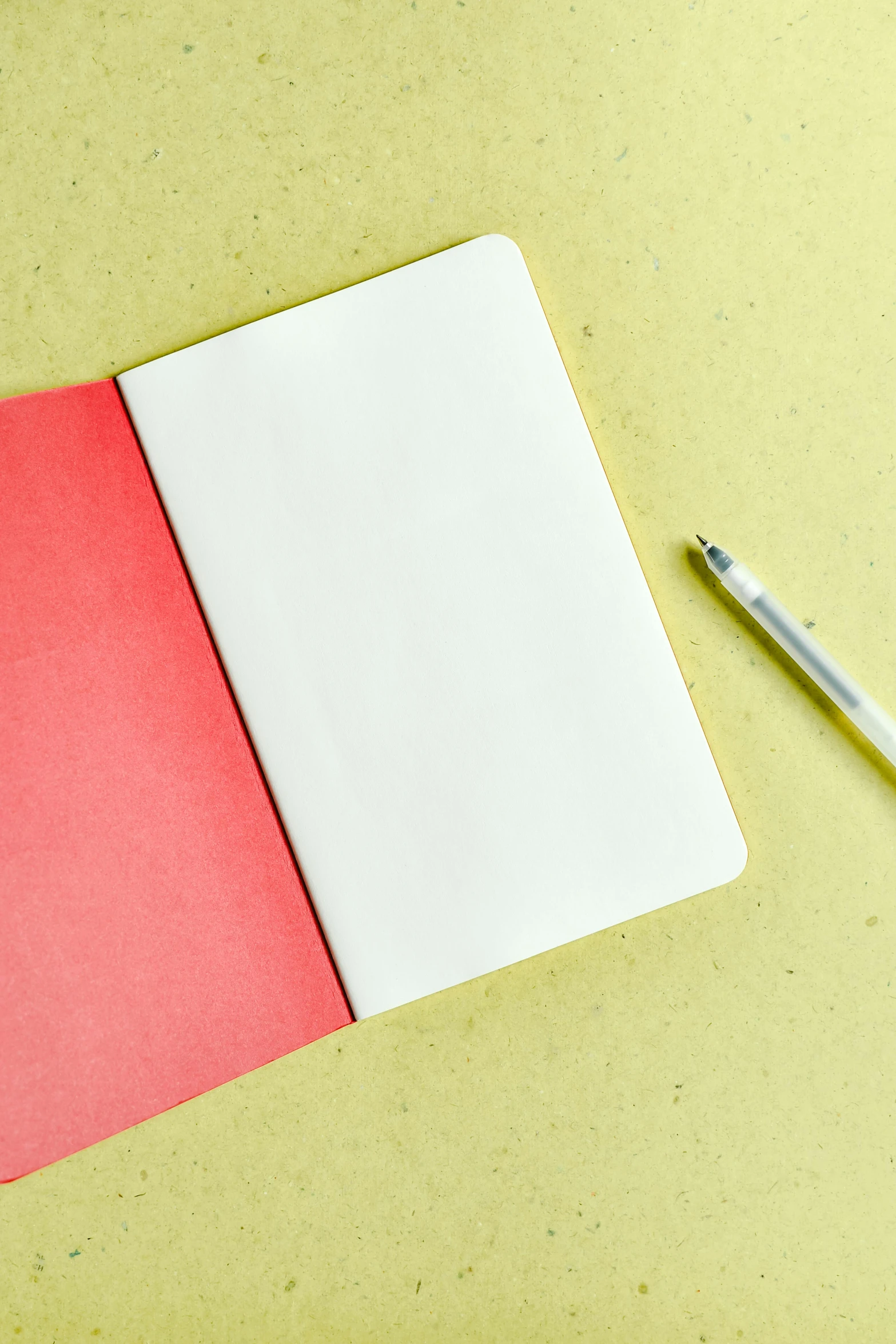 the notepad next to a pencil sits next to a sheet of paper