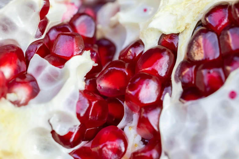 pomegranates being cut in half on a plate