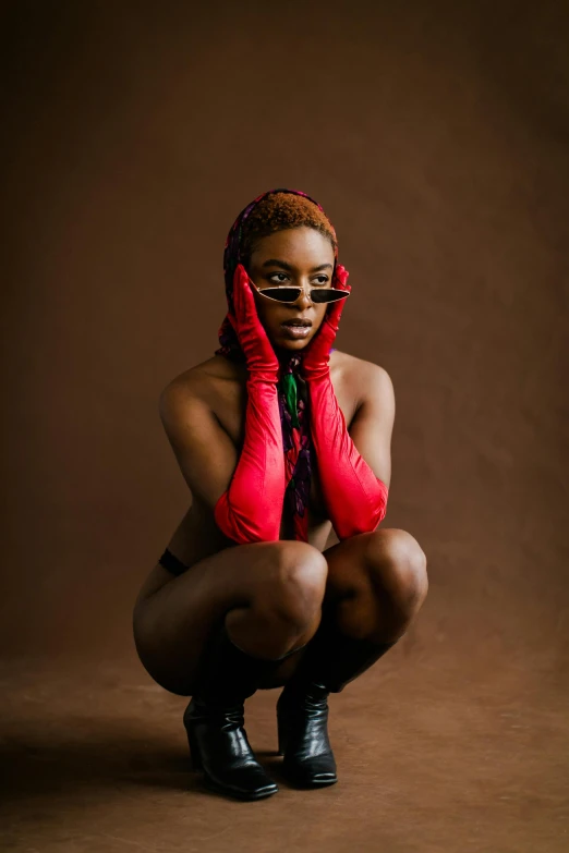 an african american woman with red gloves and bandana