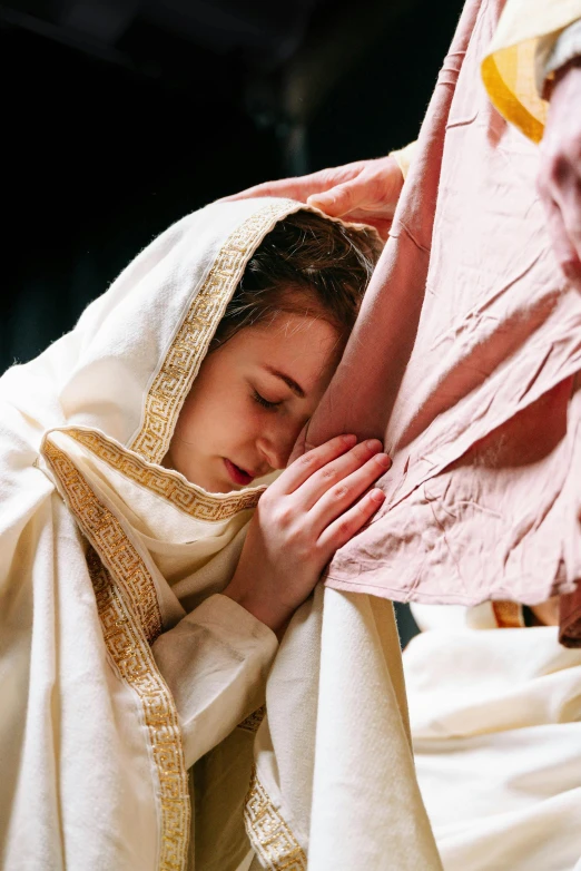 a woman in white with her face covered