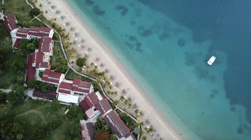 a resort overlooks the water in an aerial view