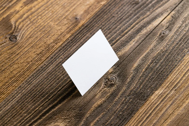 a wooden floor with a piece of white paper placed on it