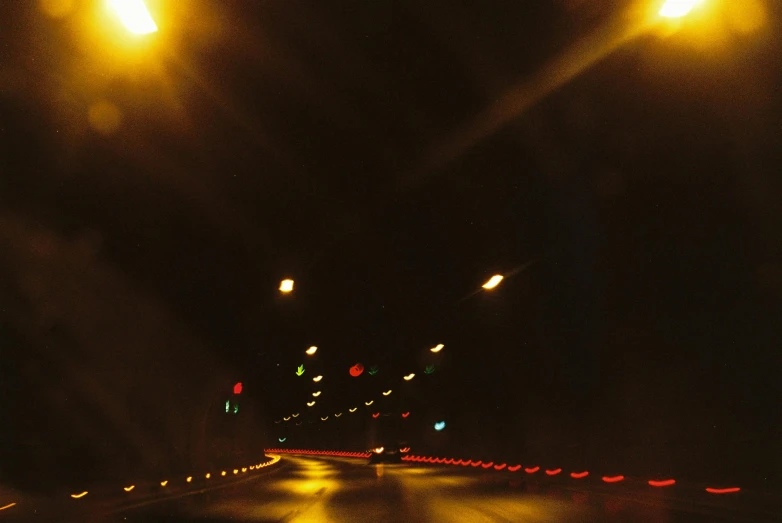 a view inside a car at night with street lights