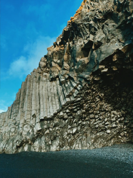 a large mountain next to a body of water