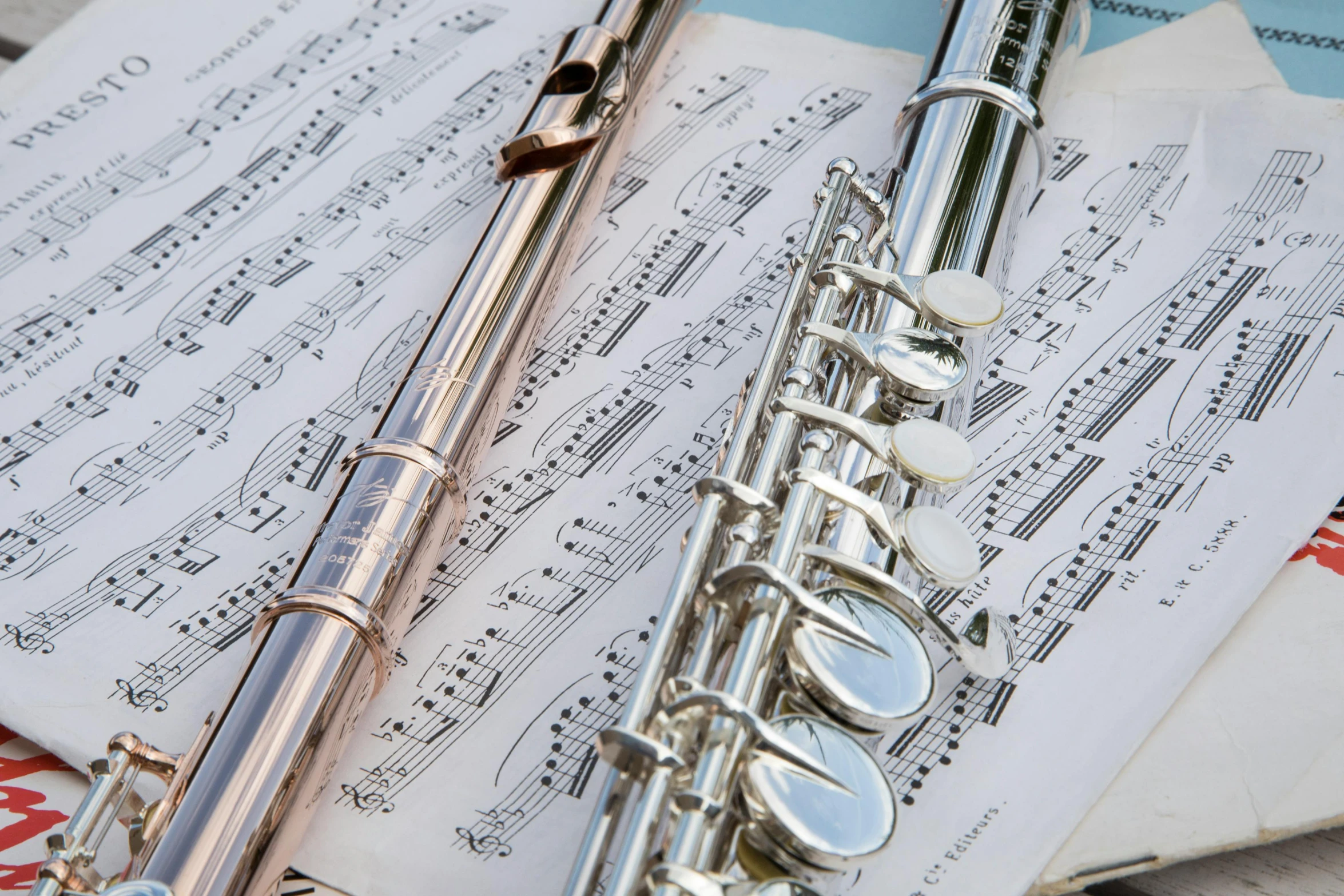 a trumpet and a microphone laying on sheet music