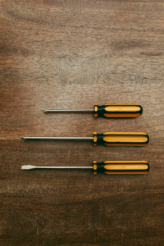 four knives laying on a table with their handles