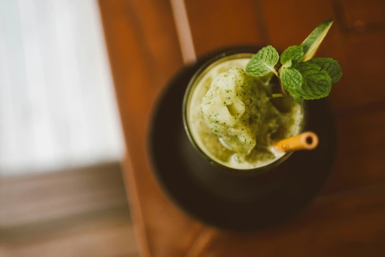 there is a mint mint mojito that is on a small bowl