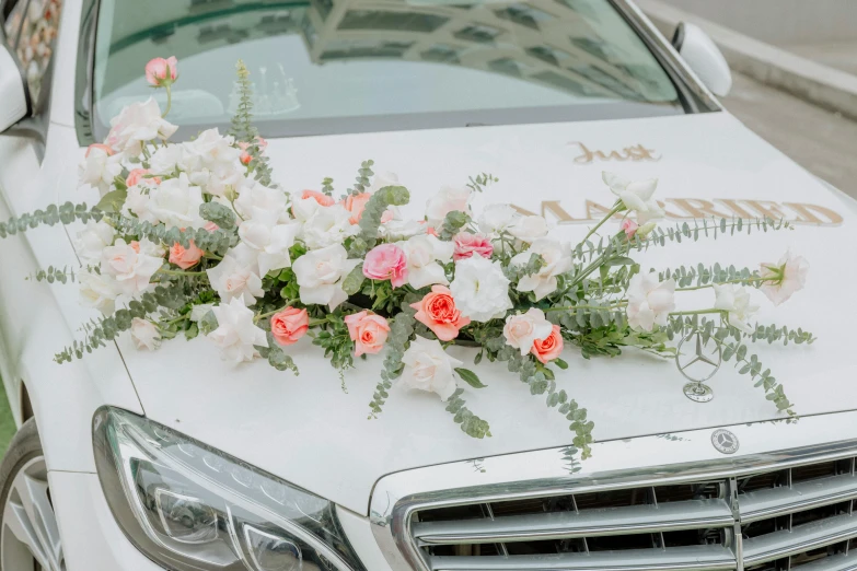 flowers laid out on top of a decorated car