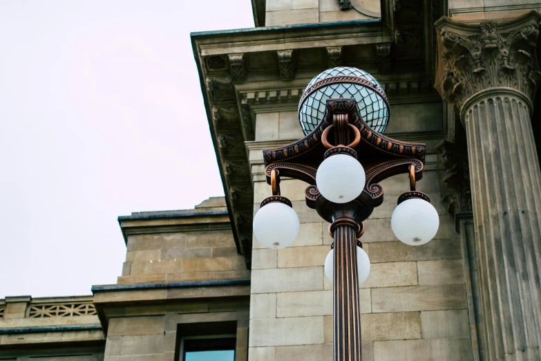 the street lamp is on the corner in front of a building