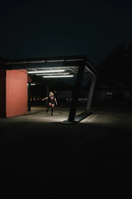 a woman standing in the dark at night