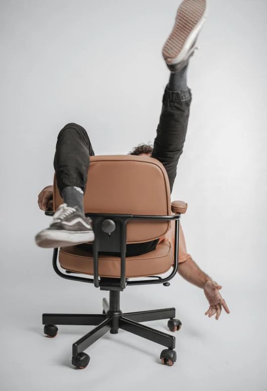 a person sitting on a chair doing a back flip