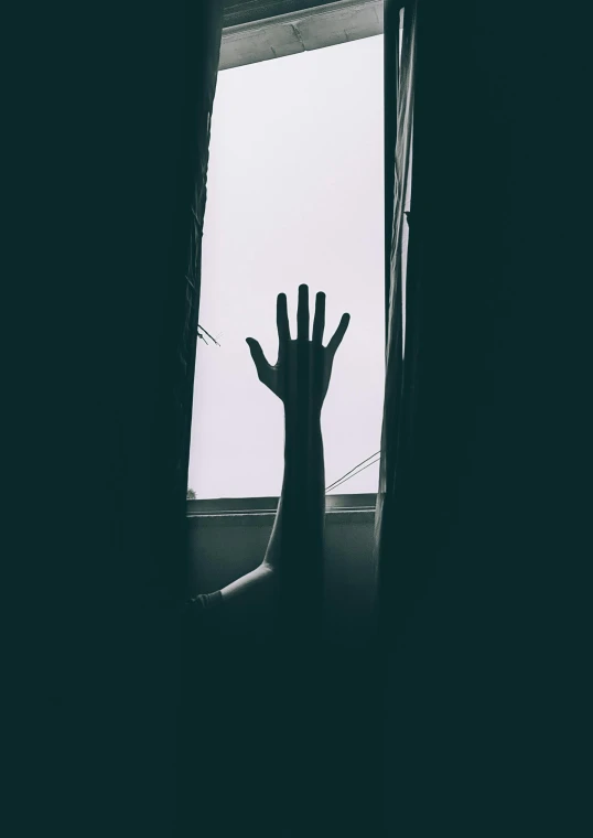 an image of someone's hand out of the window