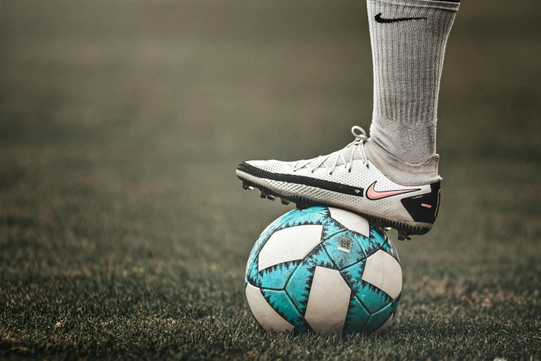 a person standing on top of a soccer ball