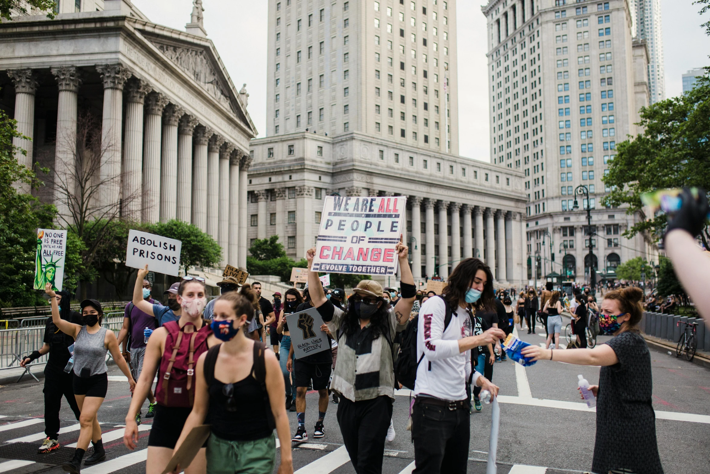 the protestors are holding their signs in front of a government building