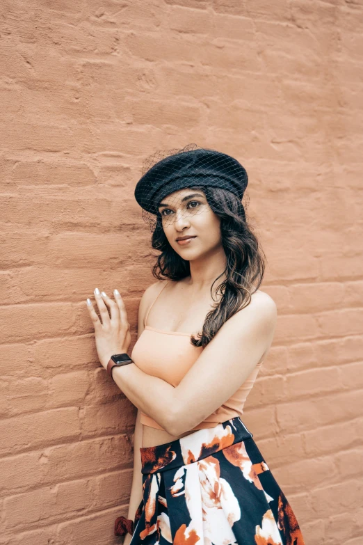 a woman wearing a dress and top, holding a cigarette