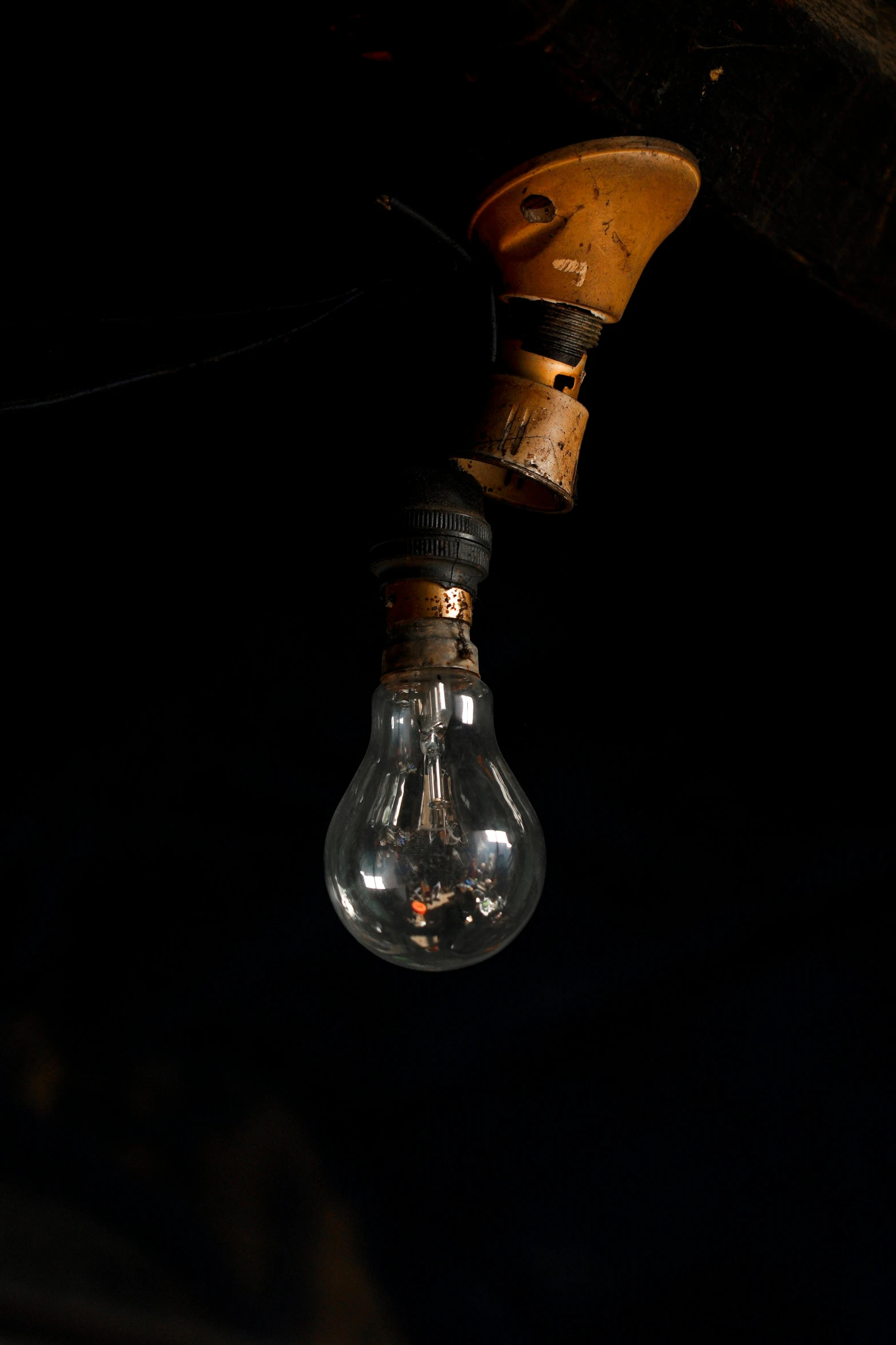 a light bulb hanging from a piece of wood