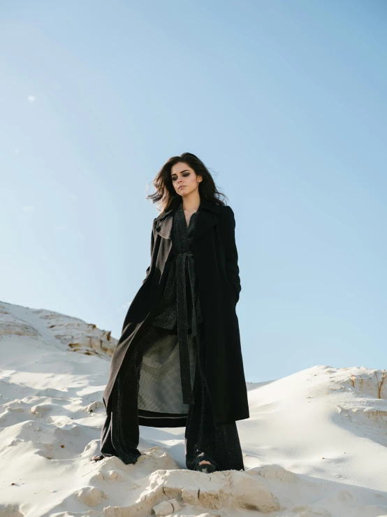 a woman standing on top of snow covered ground