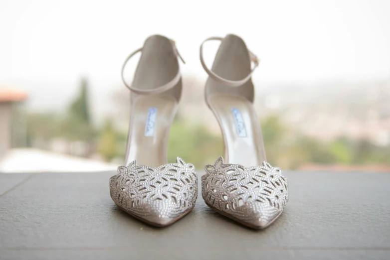 silver shoes sitting on top of a black table