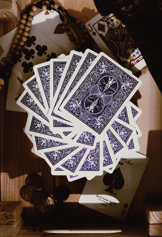 some playing cards and beads on a table