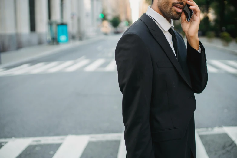 a man is on the street while talking on his cell phone