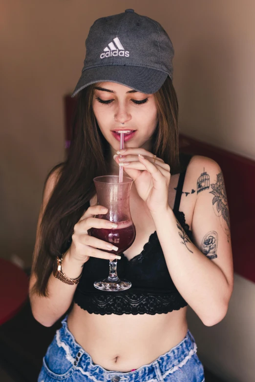 the beautiful young woman is drinking a drink