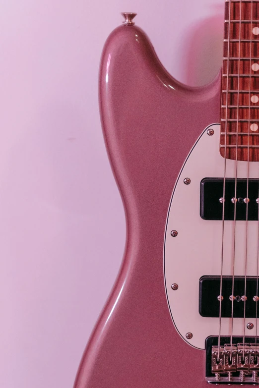 a small pink guitar lying upside down