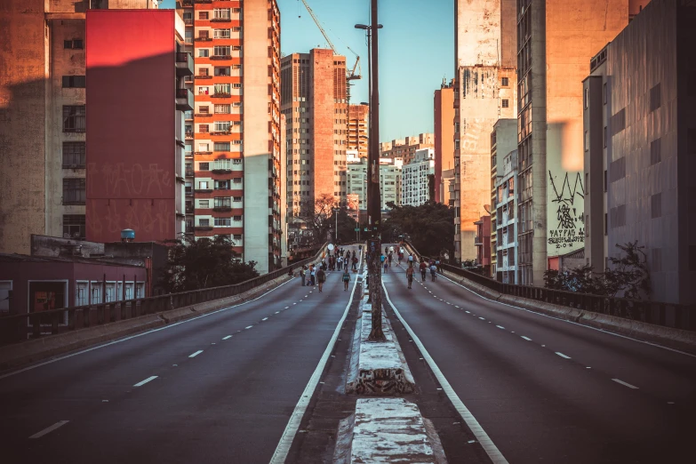 the view of people walking down the middle of a street