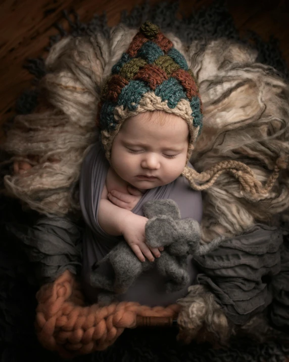 baby with teddy bear sleeps in the pile