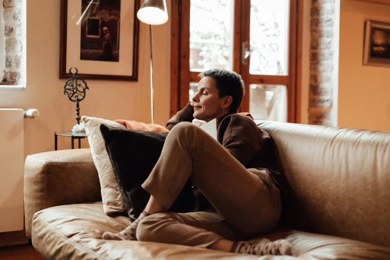 a man sits on the couch and smiles