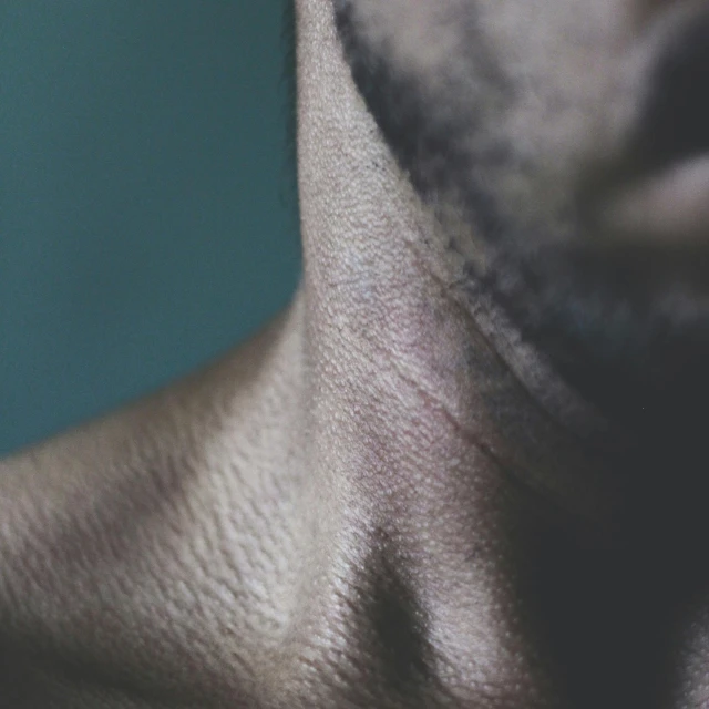 a person's neck with one side shaved