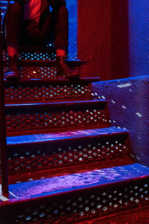 a man sitting on some stairs in a building