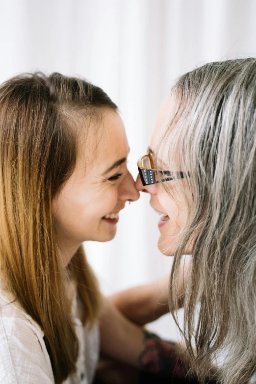 a man kissing a ladys forehead with her eyes closed