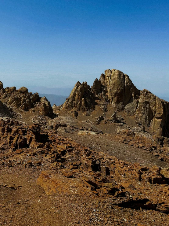 a mountain range with a large brown colored area and brown rocks