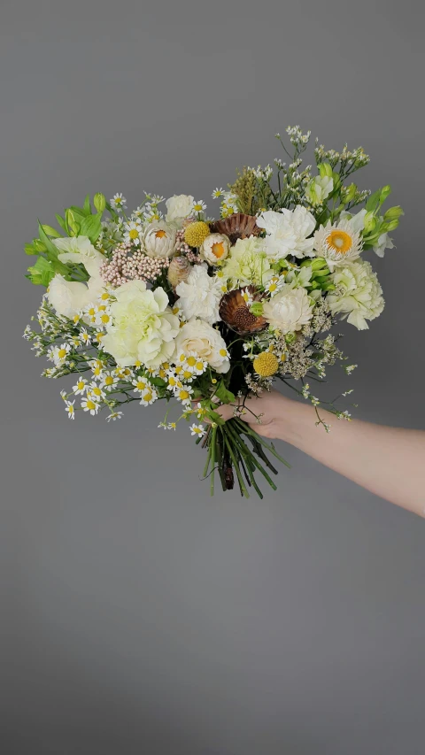 the person is holding a bouquet of flowers