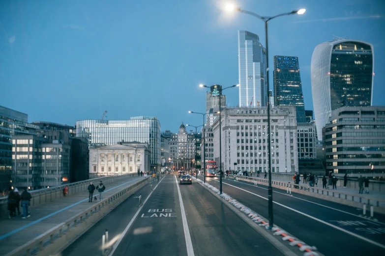 people on an empty city street during the night