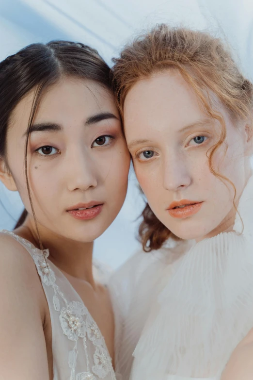 two girls wearing wedding clothes are posing for the camera