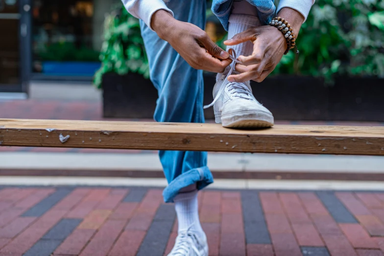 an image of a man tying a shoe