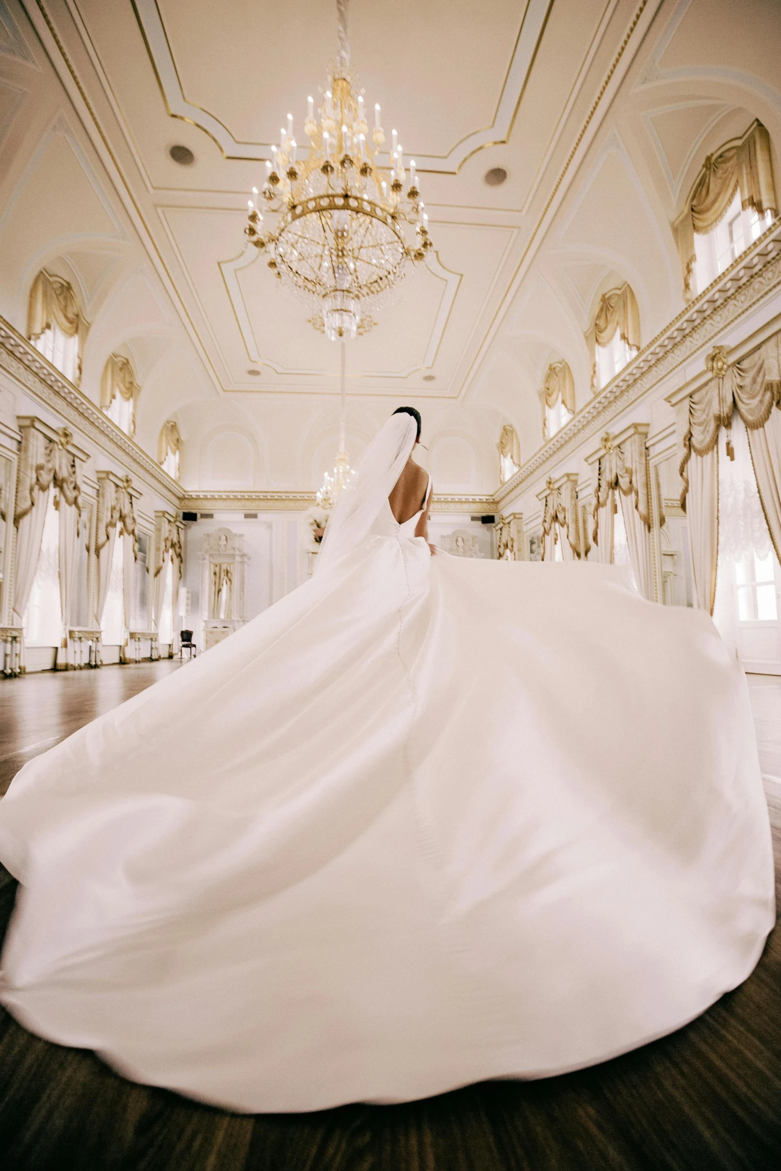 a bride posing for a po in a ballroom